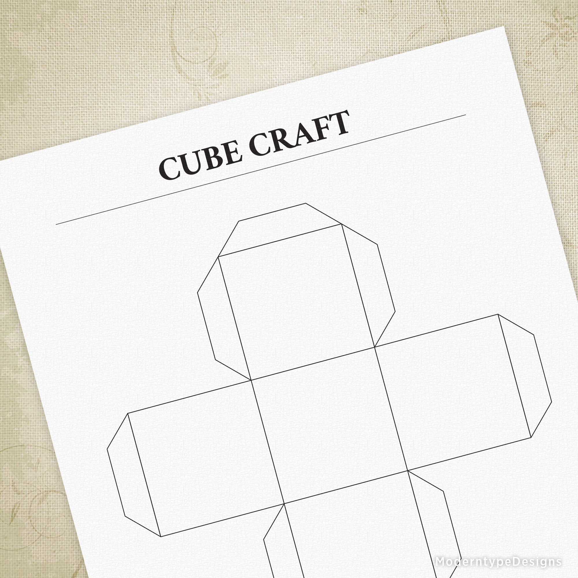 A printable cube craft template displayed on a paper with the title 'CUBE CRAFT' at the top.
