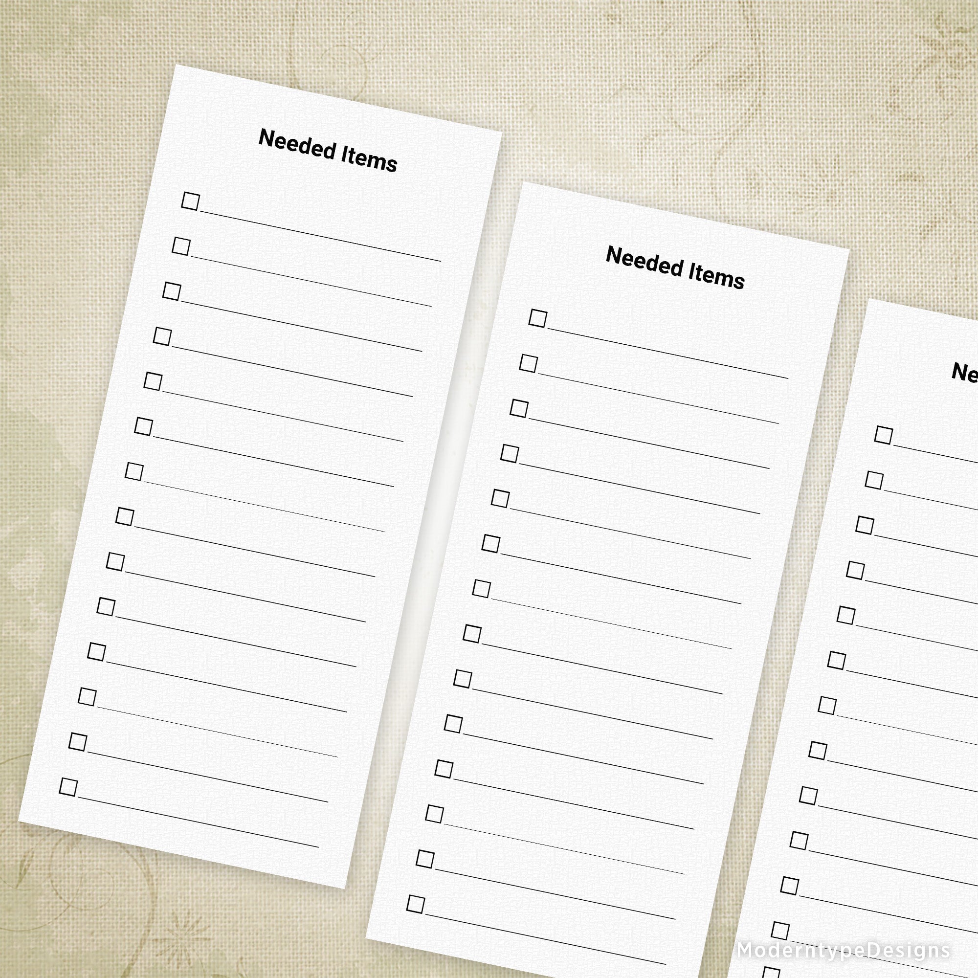 Three printed paper lists with the title 'Needed Items' written on each, placed on a textured background.