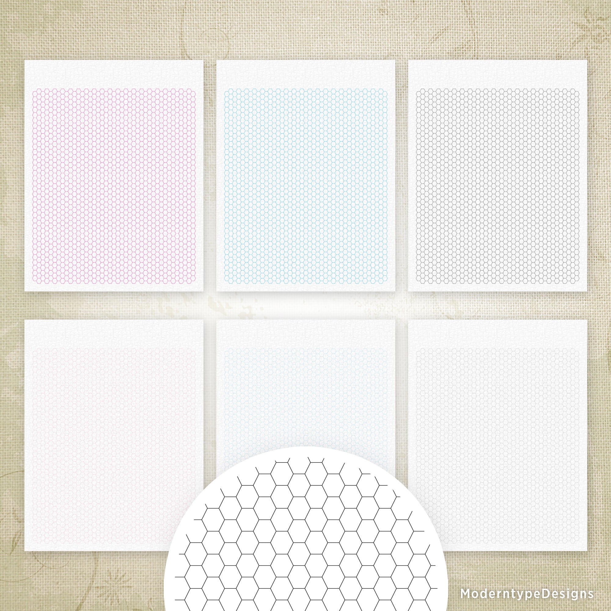 A set of printed hexagon grid paper sheets in various colors including pink, blue, white, and black, with a sample hexagon grid pattern in the foreground.