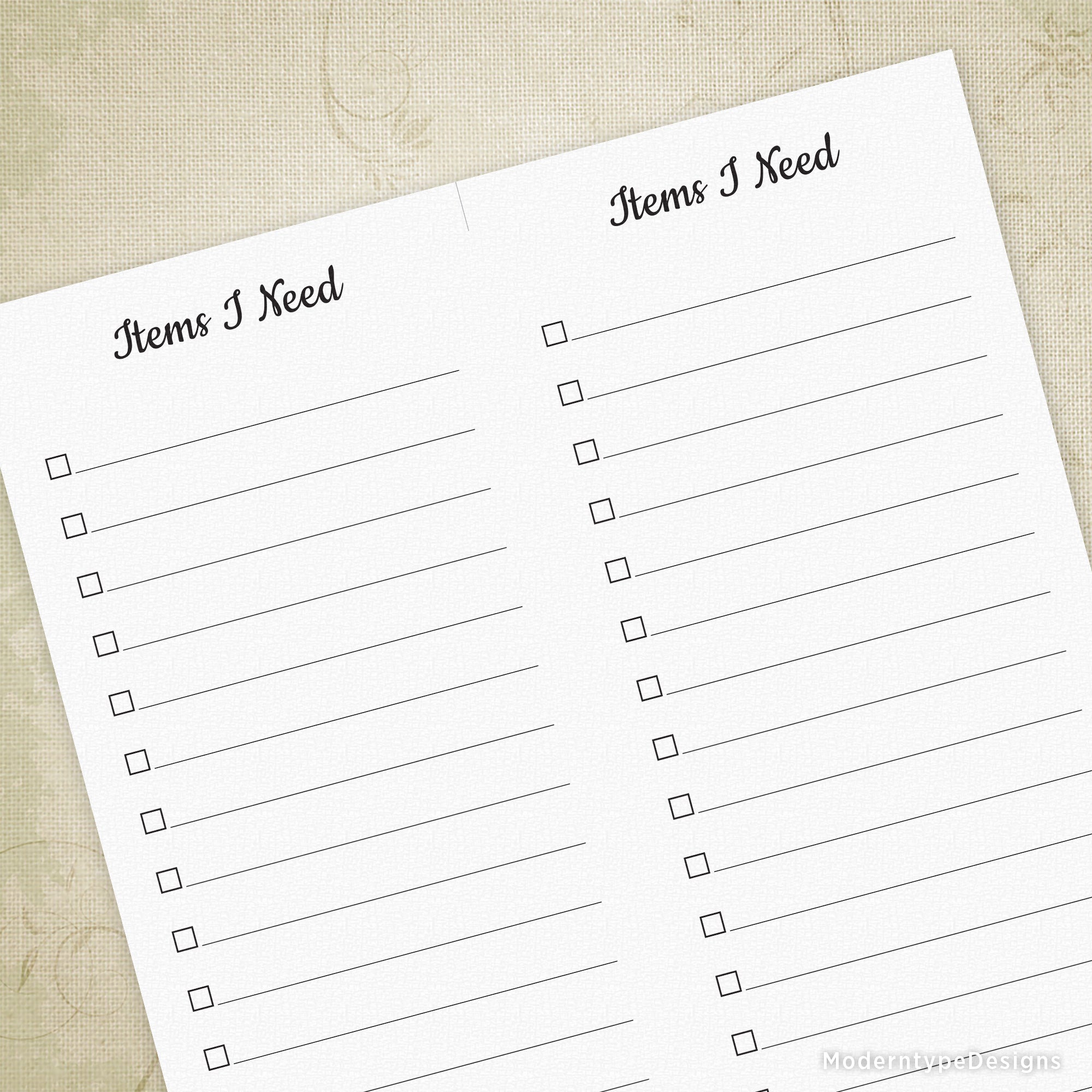 Two printable sheets with the title 'Items I Need' printed on them, arranged on a surface.