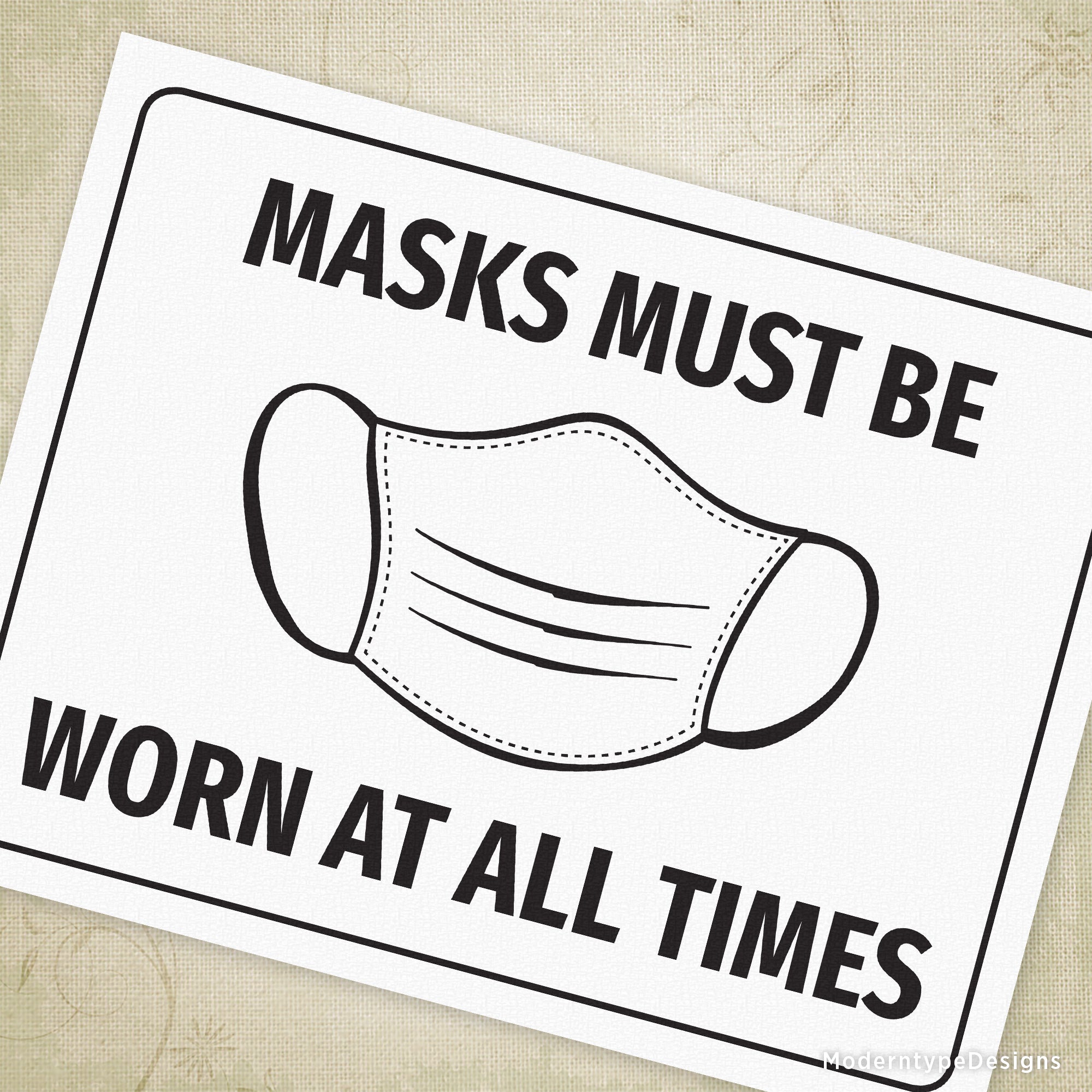 A printable sign with the text 'MASKS MUST BE WORN AT ALL TIMES' and a graphic representation of a face mask.