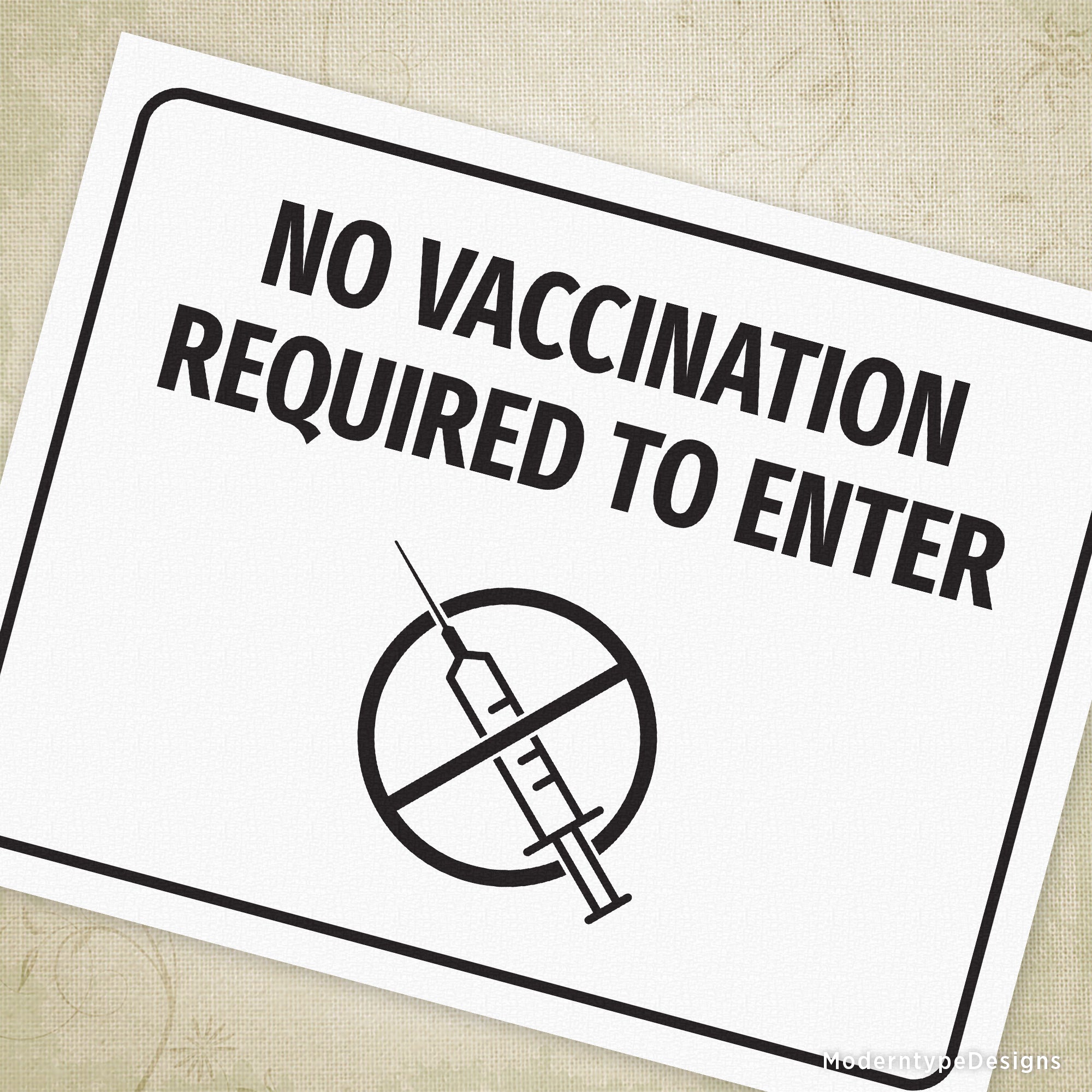 A printable sign with the text 'NO VACCINATION REQUIRED TO ENTER' and a graphic of a syringe and a prohibition sign.
