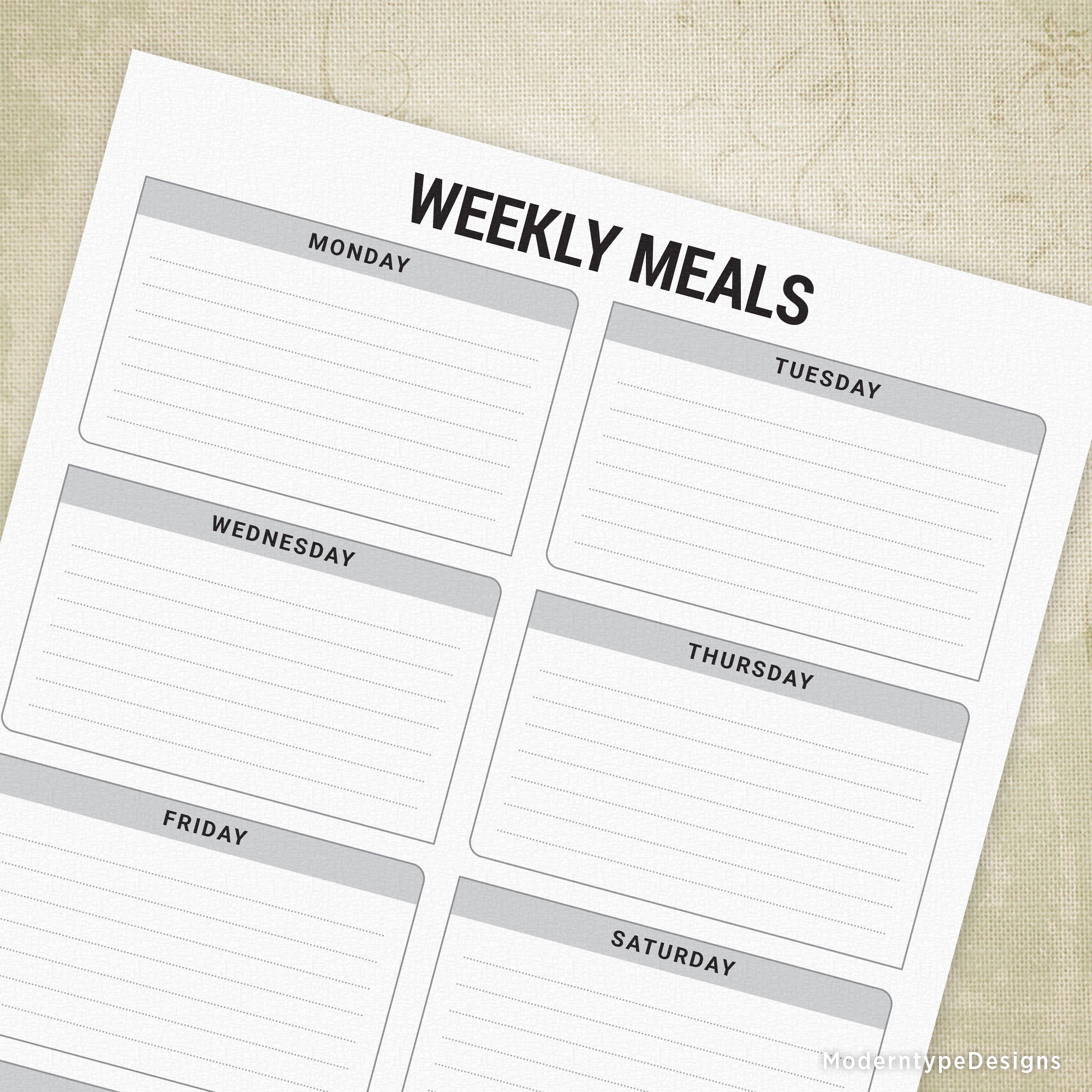 A printed Weekly Meals PDF planner with lines for each day of the week, gray and white in color, designed for tracking meal plans.